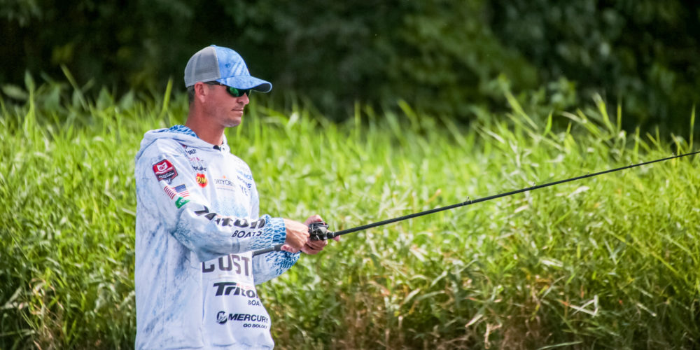 A athletic man fly fishing stands in a … – License image