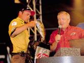 Pat Fisher weighs in a nice smallmouth as FLW Tour host Charlie Evans looks on.