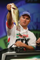 David Dudley hoists one of the bass that helped propel him into the winner