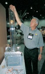 Mark Spangler of Plano drops a shot put on a piece of plastic to demonstrate the durability of the company
