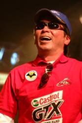 Co-angler Katsutoshi Furusawa of Toyko, Japan, shares a laugh onstage after winning a new pair of shades for his victory on Old Hickory Lake.