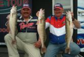 Russell McDonald and Dale Todd hold up three Lake Erie walleyes that put them both in second place.