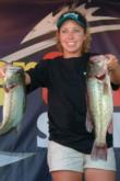 Melinda Mize holds up two of the bass that gave her the No. 2 spot on the co-angler side after day one.