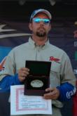 Russell Cecil with his championship belt buckle - the second he