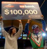 Shinichi Fukae and his wife Miyuki Fukae hoist the $100,000 winner's check at FLW Lake Okeechobee 2006.