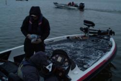 Anglers tread carefully on their snow-covered boat deck before takeoff.