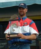 Pro winner Troy Sand holds up his first-place trophy.