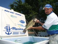 Rejuvenade's Richard Burton takes personal care of the tournament bass within the National Guard live-release area.