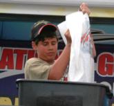 Matt Carabello hoists his catch onto the weigh-in scale. Carabello finished fifth in the 11 to 14 age division at the 2006 National Guard Junior World Championship.