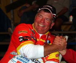 Walleye pro Eric Olson has a laugh with a member of the championship weigh-in crowd despite having a tough first day of competition.