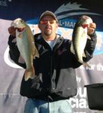 Chad Griffin holds up a pair of bass from his 12-pound, 15-ounce catch that put him in the No. 2 spot.