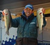 Takahiro Omori holds up two nice bass he caught on day two on Lewis Smith Lake.