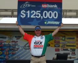 Castrol pro David Dudley holds up his first-place check for $125,000.