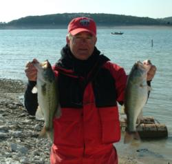 Mark Phillips shows off two bass he caught on day one of the season-opening FLW Tour event on Lake Travis.