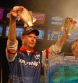 Aaron Hastings holds up his last two fish before winning the Wal-Mart FLW Tour event on Lake Travis.