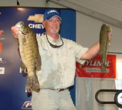 Co-angler John Barrett holds up his two biggest fish. Barrett finished the opening round in first place.