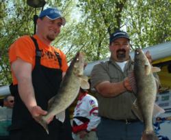 Pro Larry Snow and co-angler Erik Carlson show off their day-two catch.