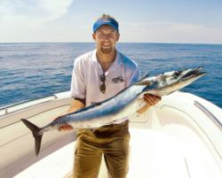 The author, Will Brantley, proudly displays a wahoo that nailed a brined ballyhoo trolled deep with an inline weight and shock leader.