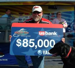 Pro winner Pete Harsh holds up his first-place check.