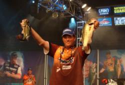 Chris Baumgardner holds up a pair of 4-pound bass that propelled him to victory Sunday.