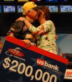 Steve Clapper of Lima, Ohio, gets a kiss from his wife after winning $200,00 in the Chevy Open.