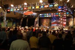 The day-two Walleye Tour Championship crowd stands at attention for the singing of the National Anthem.