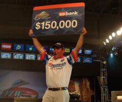 Brookings, S.D., pro Dustin Kjelden holds up his check for winning the 2007 FLW Walleye Tour Championship on Lake Erie.