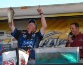 Giving the glory to God: Mark Rose points to the heavens as he unveils his winning fish.