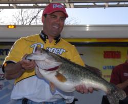 Tournament winner Clayton Meyer shows off the biggest bass of the event - a 12-pound behemoth.