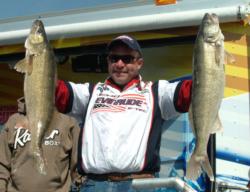 Chris Gilman holds up his two biggest walleyes from day one on Lake Erie.