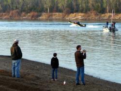 Spectators, including a gull, watch as FLW Walleye Tour boats blast off onto Lake Sharpe.