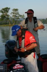 In the fourth-place boat, Ray Griffin, foreground, and his co-angler partner Robert Crosnoe strap on their PFD