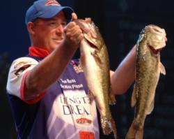 Pro Brian Travis holds up two kicker bass he caught on day one of the Forrest Wood Cup on Lake Murray. 