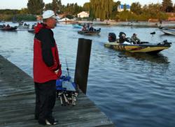 A co-angler waits for his pro during the morning boat check.