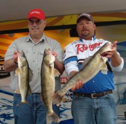 Daniel Christensen and Tom Laveque hold up part of their 18-pound, 13-ounce day-two catch.