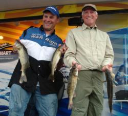 Boater Brad Dirkman and co-angler Thomas Kaus hold up four Mississippi River walleyes they caught on day three.
