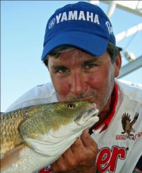 Tadd Vandemark shows his appreciation for one of the redfish that delivered his team