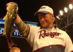Second-place co-angler Tommie Goldston holds up his kicker bass from day three on Table Rock Lake.