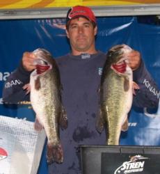 Co-angler leader Dean Kreuzer holds up two Falcon Lake hogs.