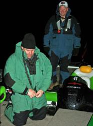 Connecticut boater Mike Kane zips up his jacket in preparation for the cold day he and co-angler Eric Lippincott will face.