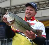 Pro Pete Gluszek holds up a 7-pound, 14-ounce Table Rock largemouth, the heaviest bass of the tournament thus far. 