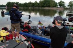Fifth-place boater Gary Edwards is interviewed for television on the final day of the All-American while co-angler Danny Robinson waits patiently to fish.