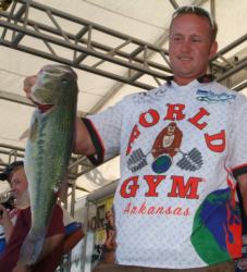 Pro Travis Fox holds up his kicker bass from day one on Kentucky Lake.