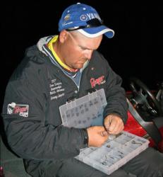 Starting the final day in fifth place, Missouri pro Jeremy Lawyer selects his tackle as he waits for the morning launch.