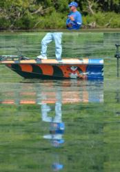 Reflections of his former self: Clark Wendlandt flips grass at Lake Champlain.