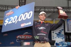 Brandon Palaniuk of Rathdrum, Idaho, shows off his first-place check after capturing the FLW Tour co-angler title on Lake Norman.