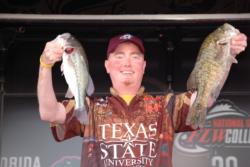Texas State University team member David Cosner proudly displays his team's second-place catch during the finals of the 2010 FLW College Fishing National Championship.
