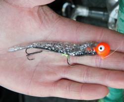 When walleyes short strike a long jig tail, adding a stinger hook near the end can convert many strikes to hook ups.