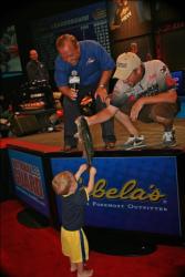 Defending 2009 Forrest Wood Cup co-angler champion Brad Roberts shows off a nice bass to his son Landon, 18 months.