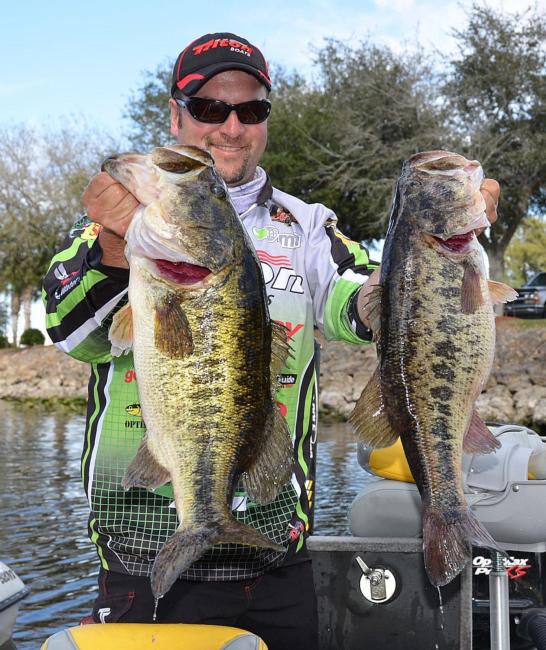 Second-place pro Fred Roumbanis holds up his two biggest bass from day two on Lake Okeechobee.